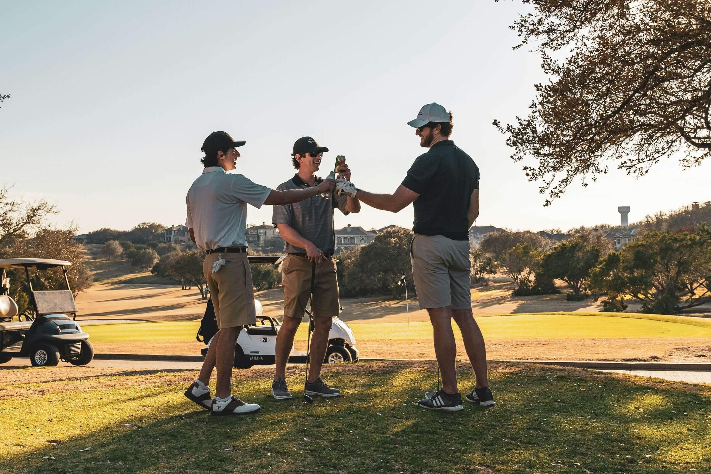 men cheers drinks on the golf course